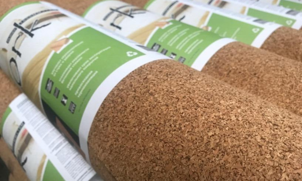 A close-up of rolled eco-friendly cork yoga mats with biodegradable packaging, showcasing sustainable and high-quality design.