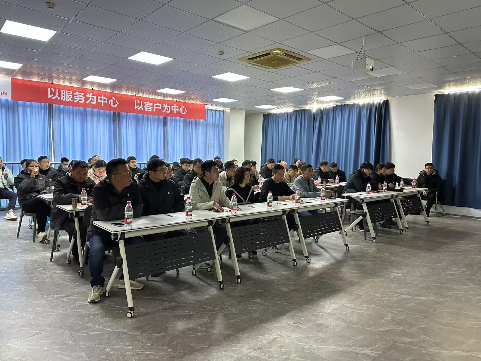 A team of Wellfitsource employees attending a training session, ensuring efficient supply chain management for bulk yoga mat production.