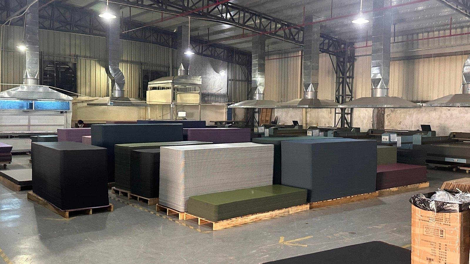 Stacks of PU yoga mats in various colors stored inside a manufacturing facility, ready for bulk supply and private label production.