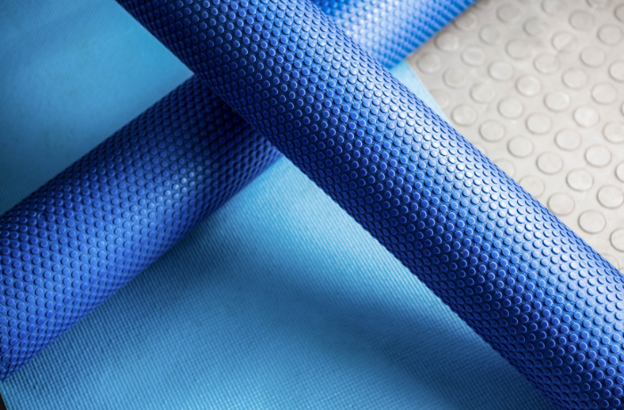 Close-up of blue textured EVA foam rollers on mat