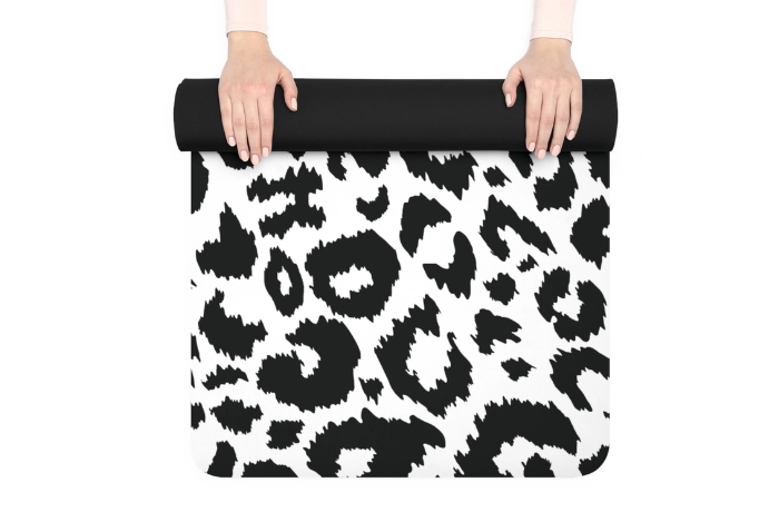 Monochrome black and white leopard print yoga mat being rolled