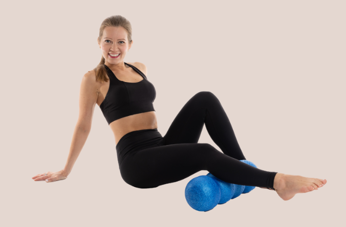 Woman using a blue foam roller for muscle recovery