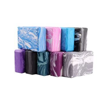 Assorted marble-pattern yoga blocks in purple, blue, and gray for stylish support