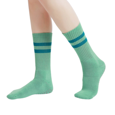 Green athletic yoga socks with dual blue stripes and grip base