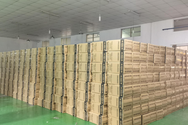 Rows of sealed cardboard cartons on pallets in warehouse, each marked ‘Yoga Block’ ready for export