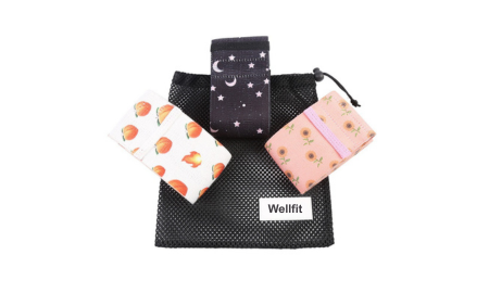 Wellfit fabric resistance bands in different colors and patterns, packaged with a drawstring pouch.