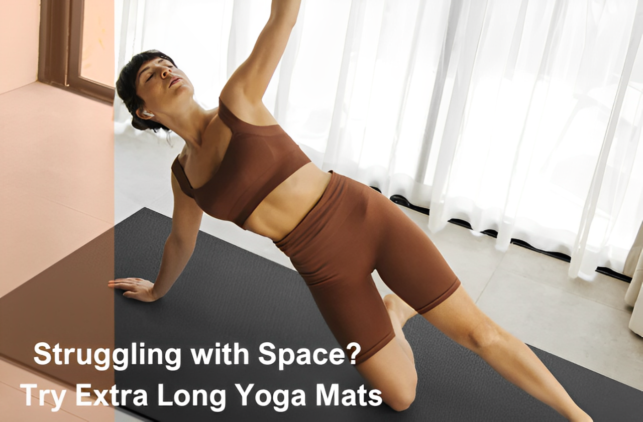Woman practicing yoga side plank on an extra long black yoga mat in a sunlit room