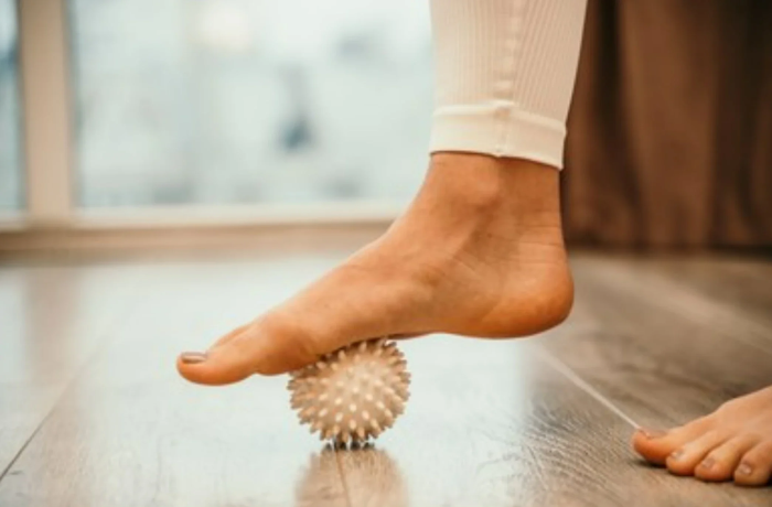 Arch Relief Using Spiky Foot Massager with Balls
