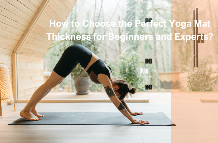 Woman practicing downward dog pose on a yoga mat in a wooden home studio.