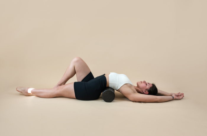Woman using foam roller for back pain relief