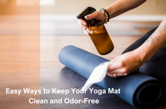 Person spraying and wiping a yoga mat with natural cleaner to remove sweat and odor.