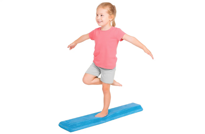 Child balancing on foam beam during sensory play