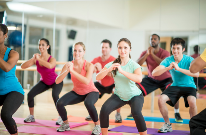 Group fitness training session using custom fitness products, showing brand loyalty and private-molded product demand.