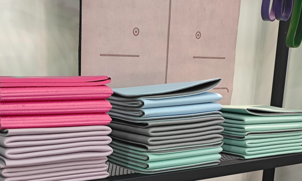 Foldable yoga mats stacked in bulk on display shelf
