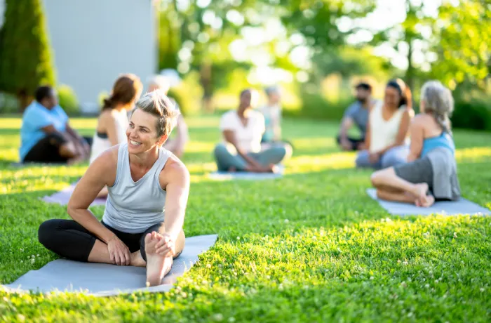 Branded yoga mats at outdoor pop-up yoga community event
