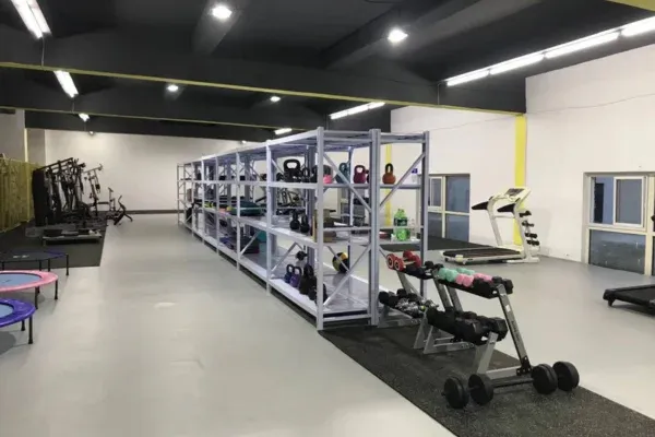 Full view of commercial gym dumbbell and kettlebell inventory shelving