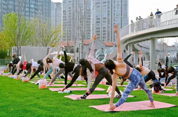 Large outdoor yoga event with custom mats for brand promotion
