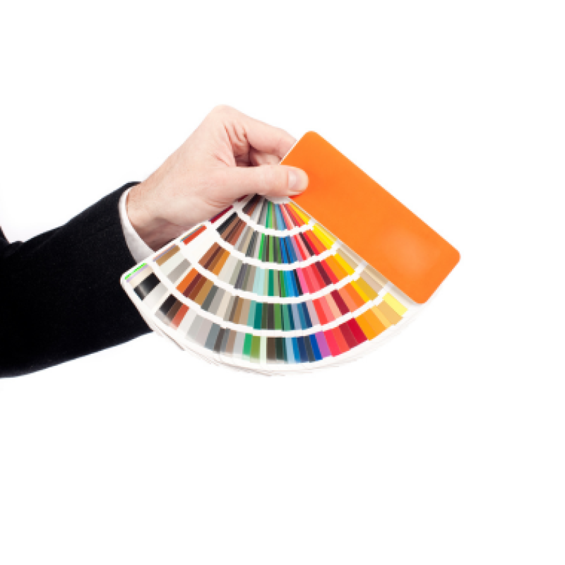 Hand holding a Pantone color chart for resistance band color selection
