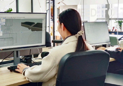 A designer creating a custom yoga and fitness product using professional CAD software at Wellfitsource.