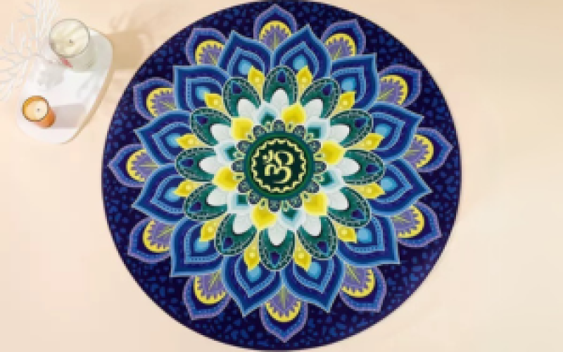 Round suede yoga mat with vibrant mandala pattern for meditation and practice